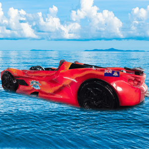 A red car floating on top of water.